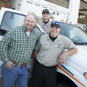 Mercy paramedics Kenny Dalton and Casey Fowler pose with Josh Britt 
