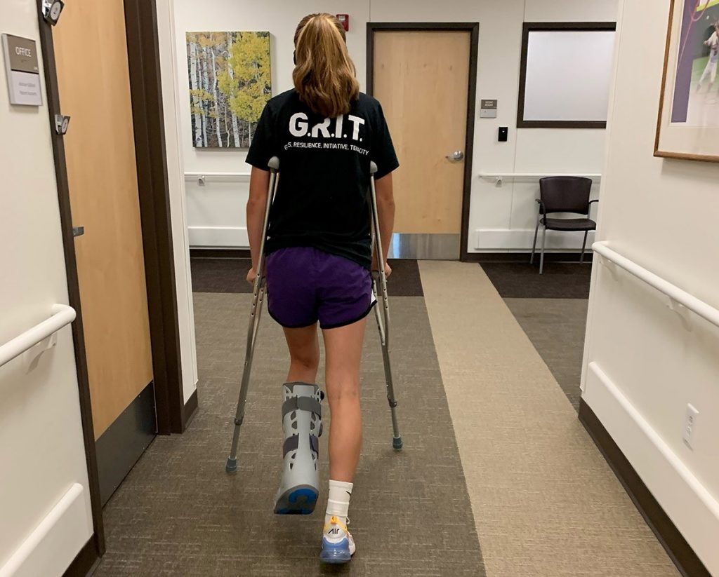 Taylor Green leaves Mercy Orthopedic Walk-in Care in a boot, after fracturing her ankle during a basketball game.