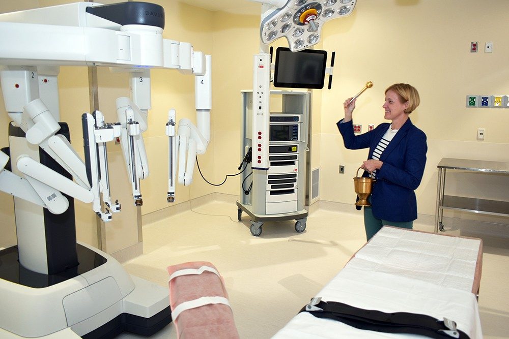 Amie Koenen, Mercy Jefferson executive director of mission, blesses the da Vinci Robotic Surgical System suite.