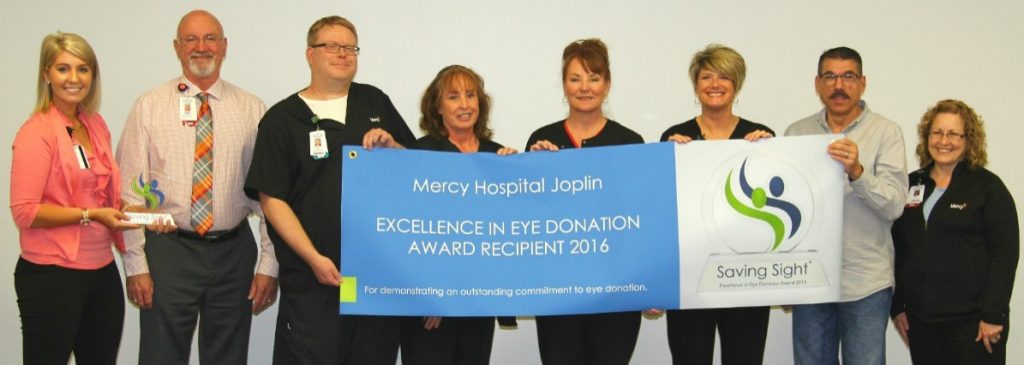 Haley Lyne (far left) of Saving Sight presents the Excellence in Eye Donation Award to Dennis Manley (second from left), chief nursing officer of Mercy Hospital Joplin.
