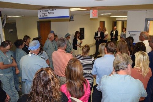 During the dedication ceremony, co-workers gathered in the Third Floor OR hallway at Mercy Hospital Springfield, where one of the four Shipman legacy stones is mounted on the wall.

